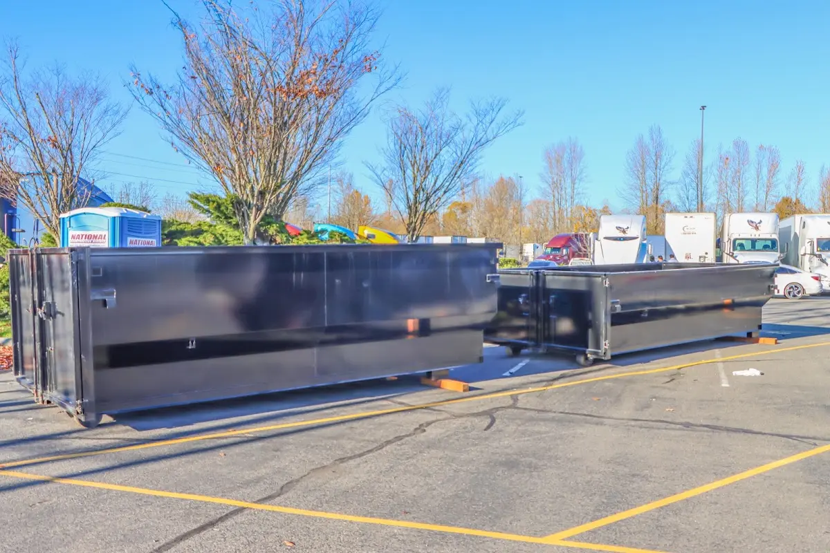 Professional dumpster rental service with roll-off container on residential driveway in Willow Springs